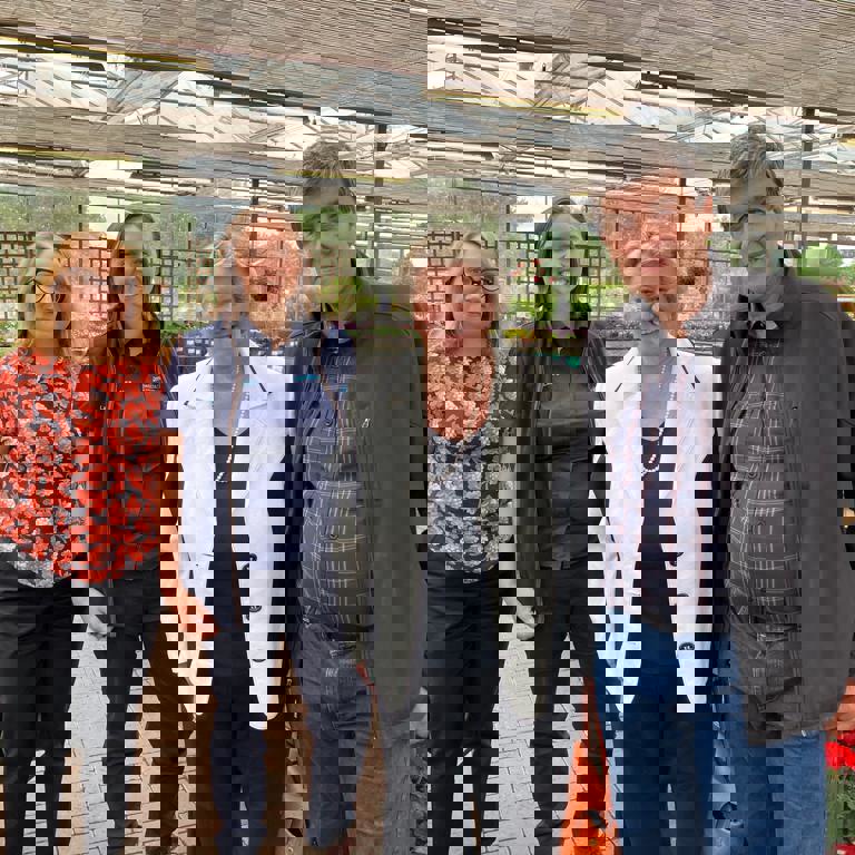 L-R Jennifer Pheasey from the HTA, Laura Jackson, Heather Wheeler MP and John Jackson standing in a garden centre surrounded by plants